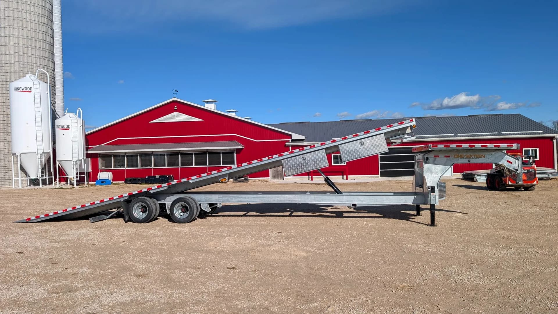 One Sixteen gooseneck tilt-deck trailer raised for loading