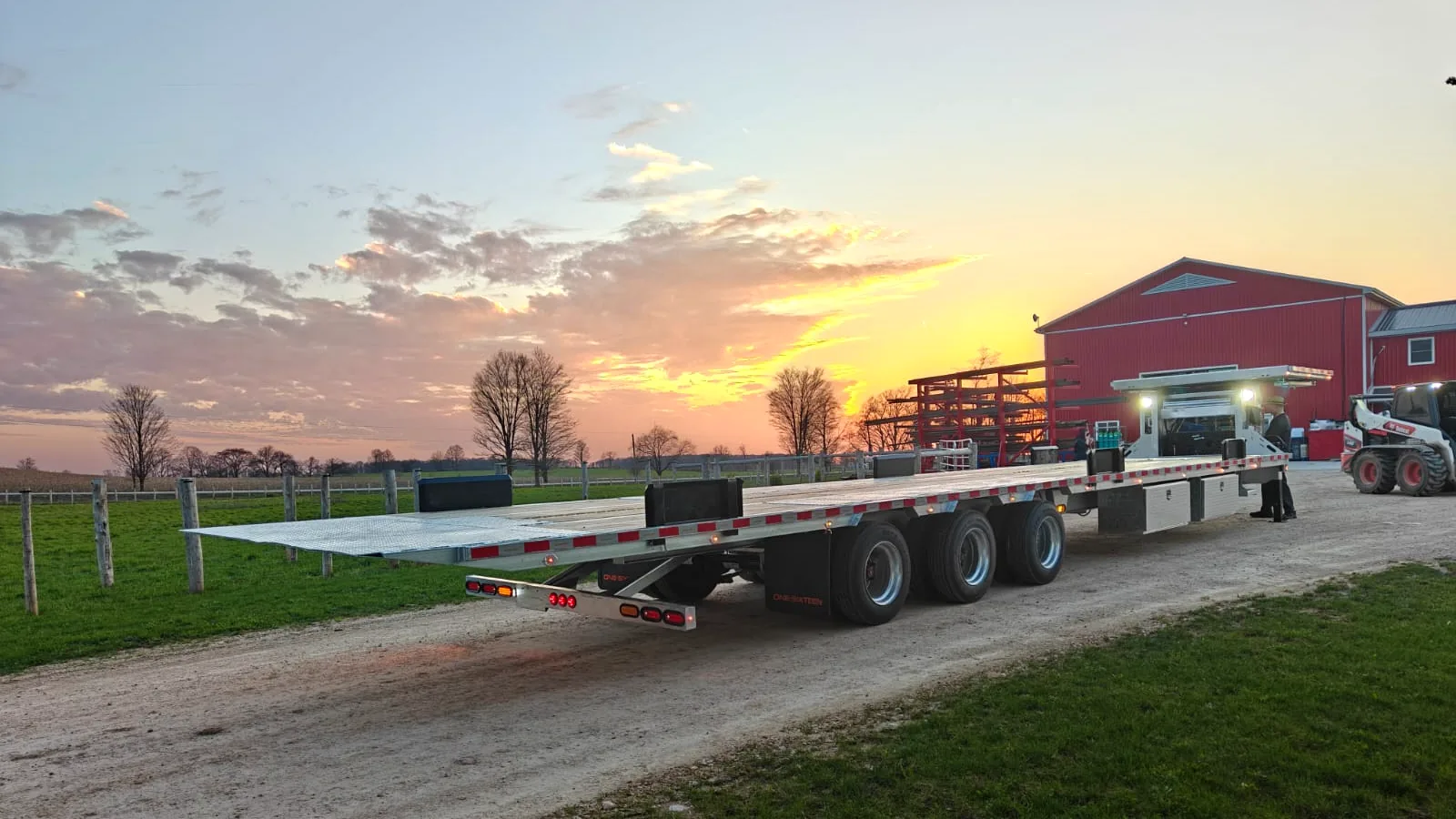 One Sixteen triple-axle flatdeck trailer at sunset