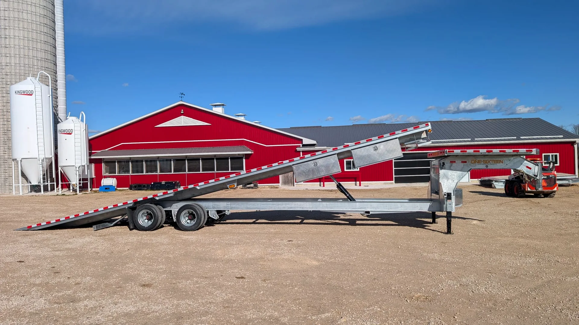 One Sixteen gooseneck tilt-deck trailer raised for loading